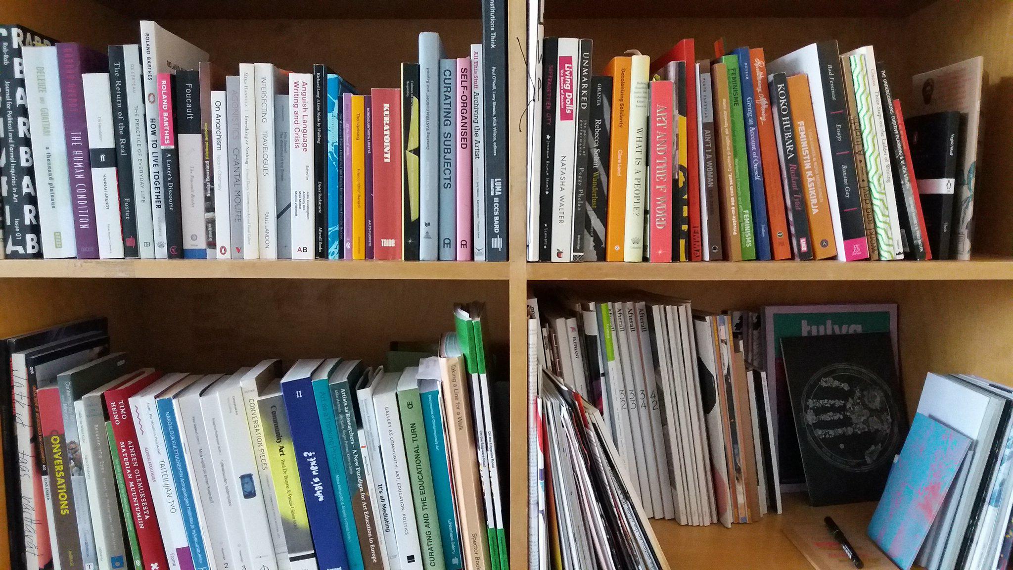 photo of nynnyt bookshelf, showing four sections full of books